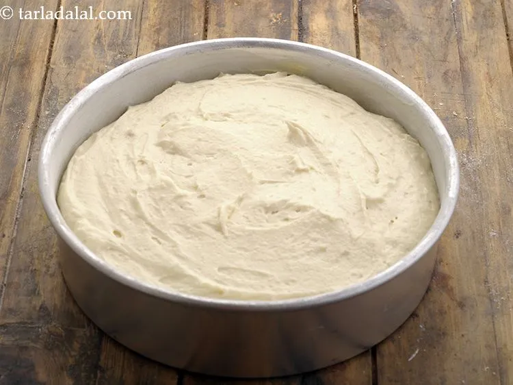 Step 28 – Pour the <strong>vanilla sponge cake</strong> batter into it and smoothen the top.