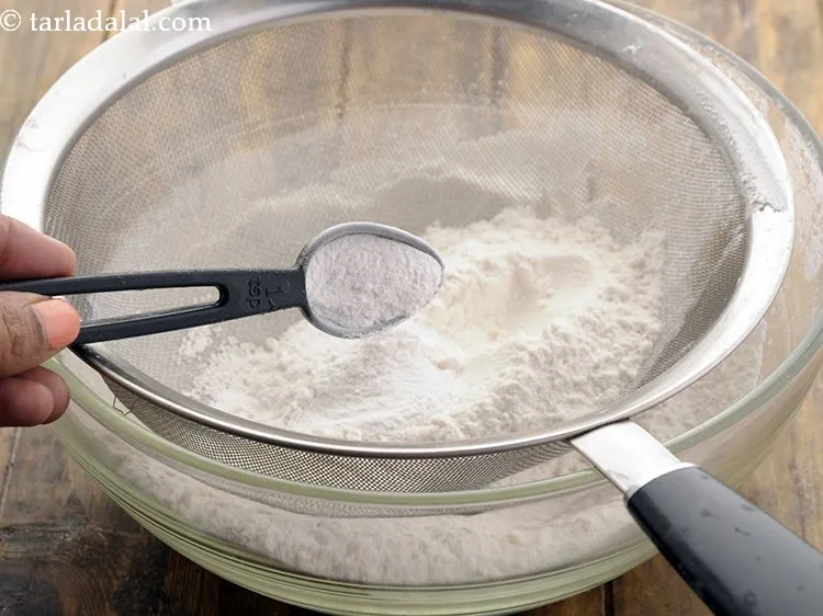 Step 12 – Add baking powder. It is a leavening agent used to give the <strong>sponge cake</strong> rise.