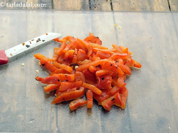 Step 21 – Cut the capsicum into thin slices using a sharp knife. Keep aside.