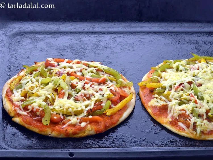 Step 32 – Place both the pizzas on a greased baking tray and bake in a pre-heated oven …