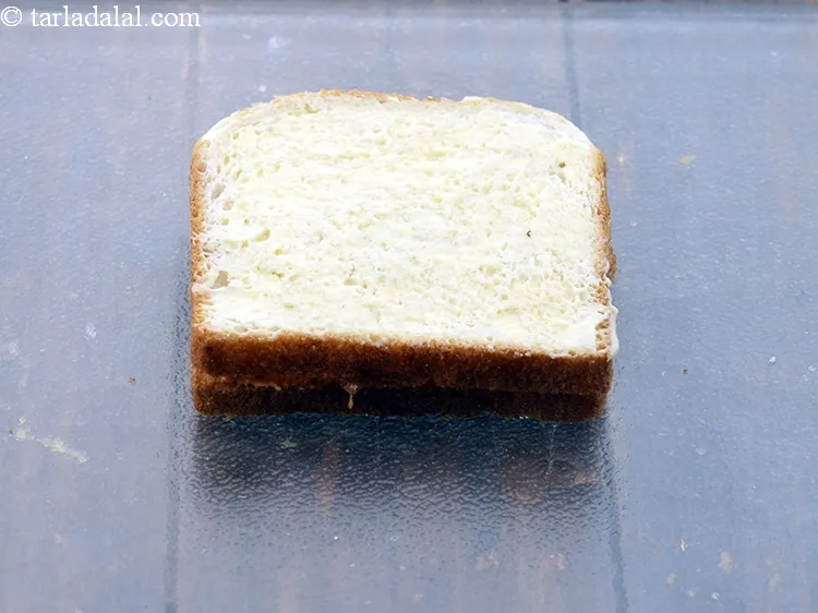 Step 19 – Brush &frac12; tsp of <a href="https://www.tarladalal.com/glossary-butter-makhan-233i">butter</a>&nbsp;evenly over it.
