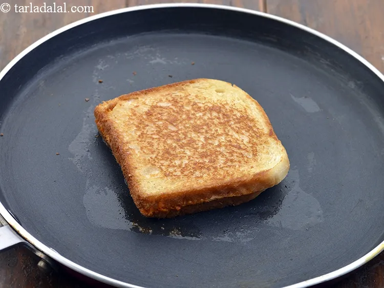 Step 20 – Heat a non-stick a tava (griddle), put &frac12; tsp of <a href="https://www.tarladalal.com/glossary-butter-makhan-233i">butter</a>&nbsp;and place the sandwich …