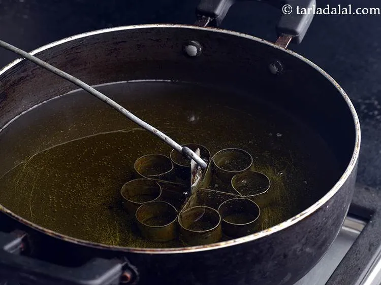 Step 4 – Dip the rose cookie mould in the hot oil. And allow it to heat up …