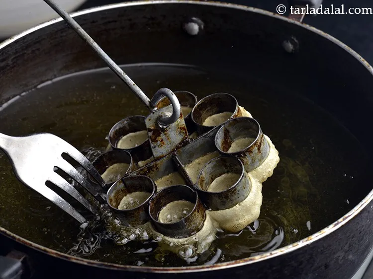 Step 6 – Dip the mould again in the hot oil and as the cookie cooks, loosen the …