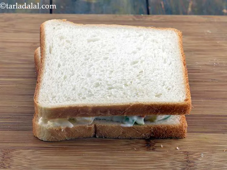 Step 16 – Cover it using another bread slice with the buttered side facing downwards.