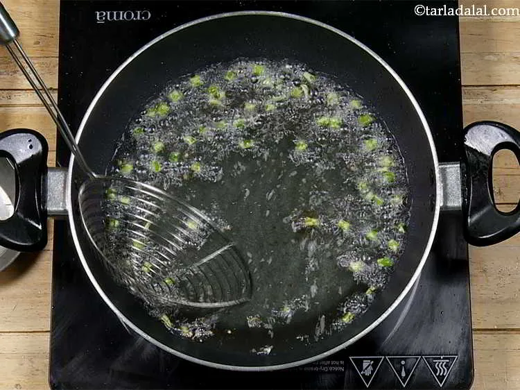 Step 6 – In the same oil deep-fry the green chillies. Drain on an absorbent paper. Keep aside.
