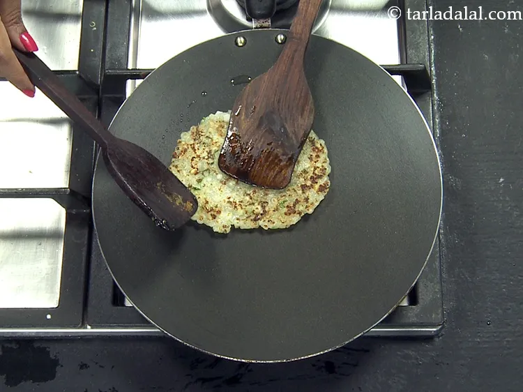 Step 48 – Cook the thalipeeth till it turns golden brown in colour from one side and then …