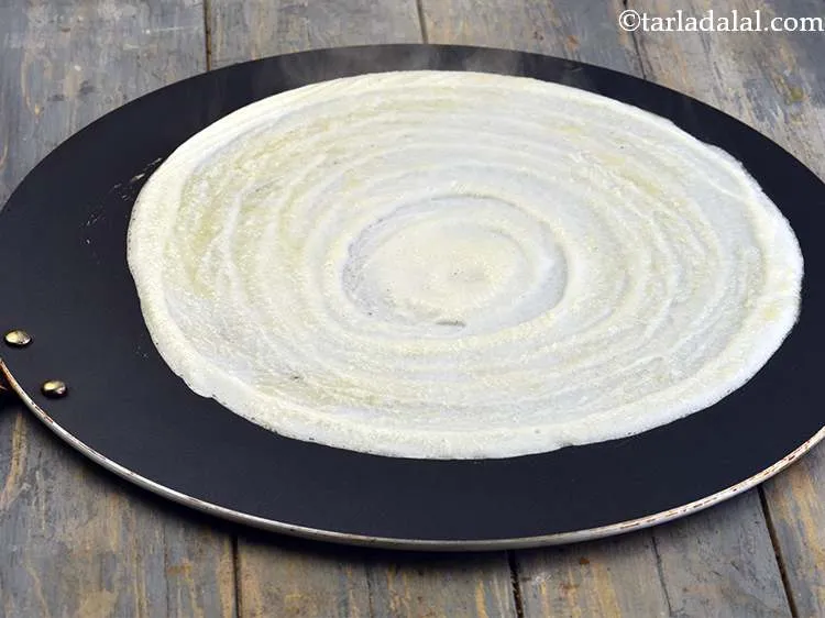 Step 47 – Smear a little ghee over it and along the edges. You can also use butter …