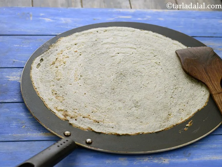 Step 48 – Cook on a high flame till the&nbsp;<strong>dosa</strong>&nbsp;turns brown in colour and crisp. No need to …