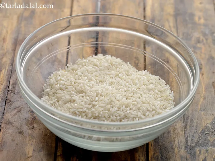 Step 28 – In another bowl, take rice. Here we have used raw variety of rice.
