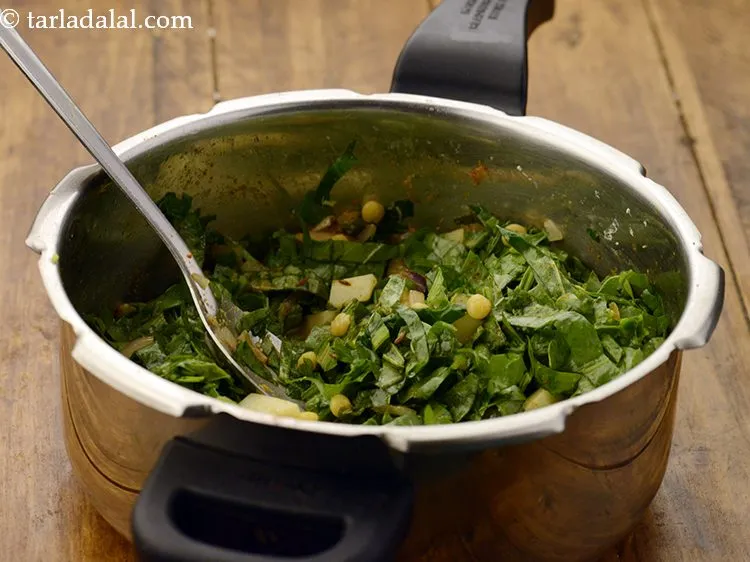 Step 25 – Add &frac12; cup of water to adjust the consistency of the sabzi.&nbsp;Mix well.