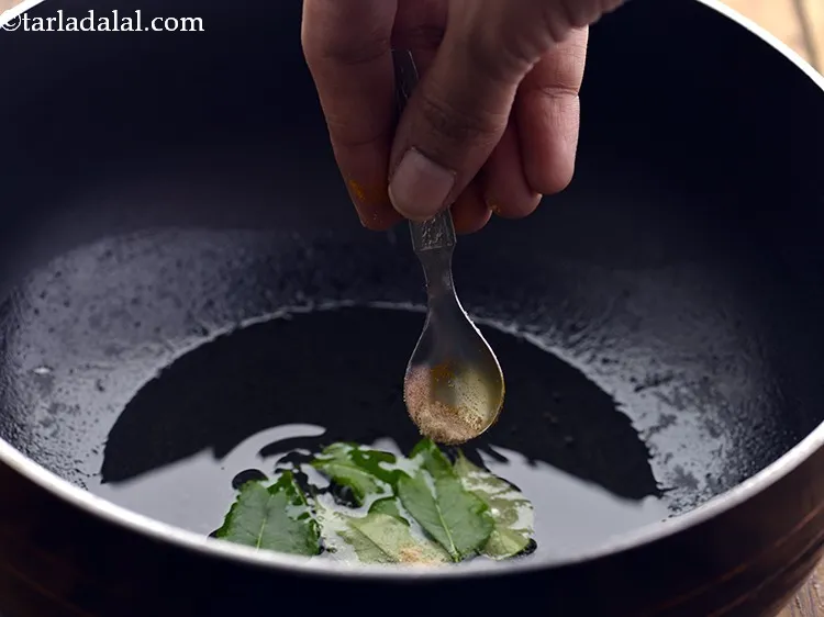 Step 49 – <p>Add the curry leaves and asafoetida. Fresh kadi patta is a must ingredient while tempering …