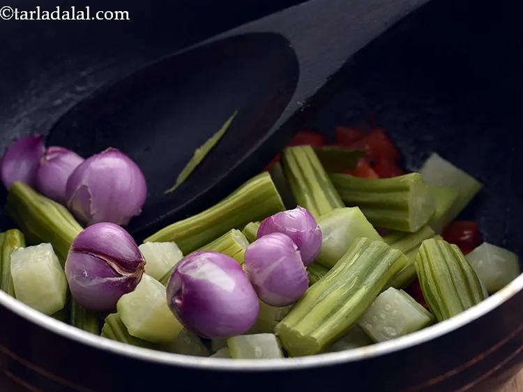 Step 54 – <p>Add the shallots. If you don’t have sambar onions then make use of regular onions.</p>