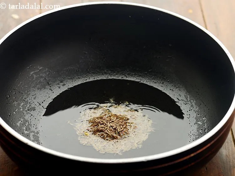 Step 3 – Once the ghee is hot, add cumin seeds.