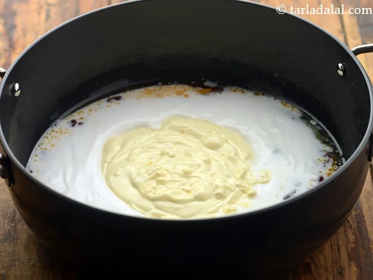 Step 13 – Add the prepared curd-besan mixture.&nbsp;