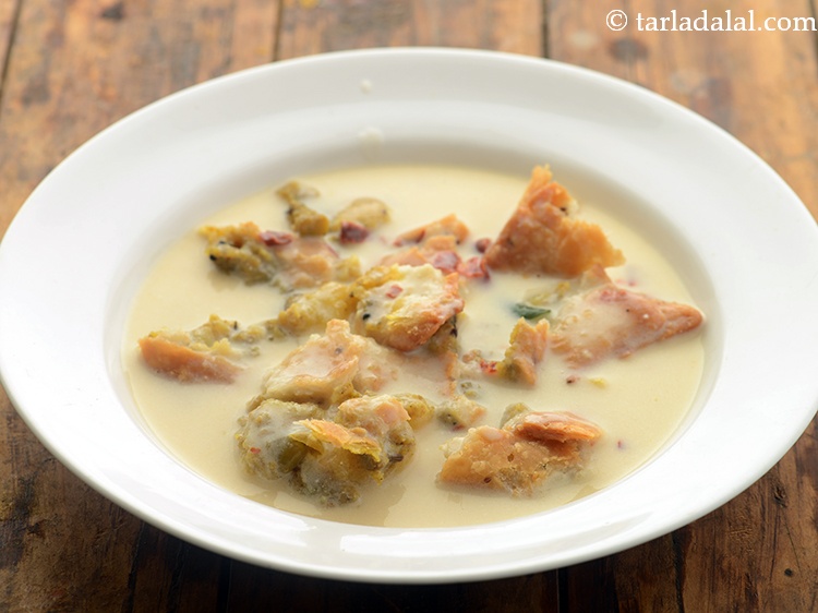 Step 19 – Pour half of the prepared kadhi over it.&nbsp;