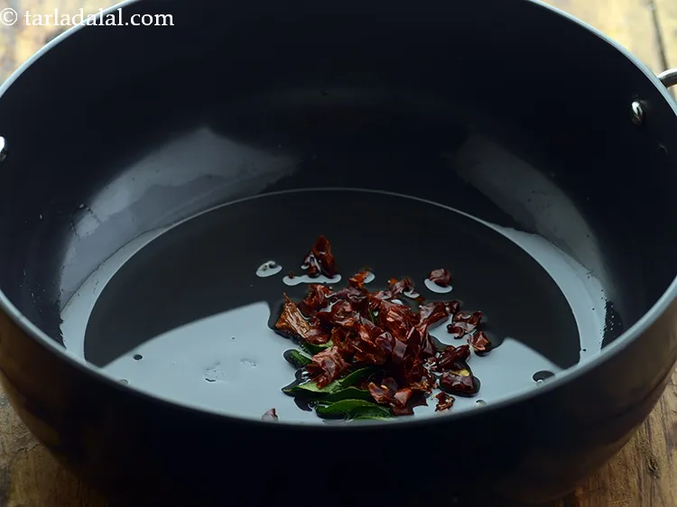 Step 10 – Add red chillies. You can adjust the quantity according to your preference.&nbsp;