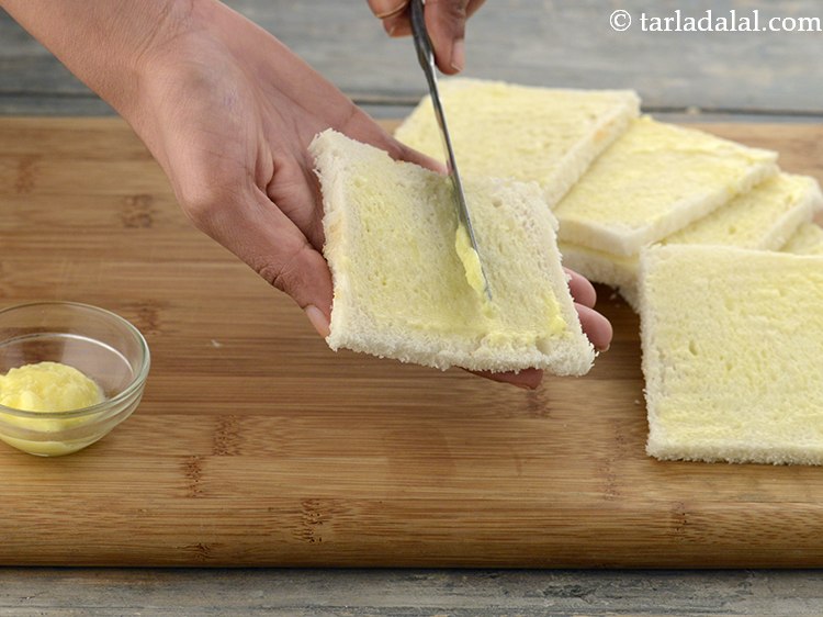 Step 40 – Spread &frac12; tsp of <a href="https://www.tarladalal.com/glossary-butter-makhan-233i">butter</a>&nbsp;on each of the 5 bread slices and keep aside.