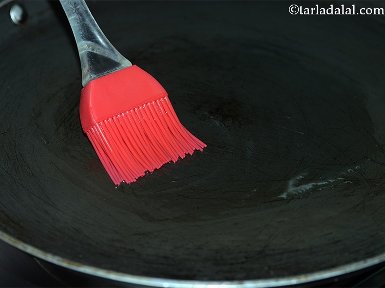 Step 22 – Grease the tava (griddle), with a little <a href="https://www.tarladalal.com/glossary-oil-671i">oil</a>.