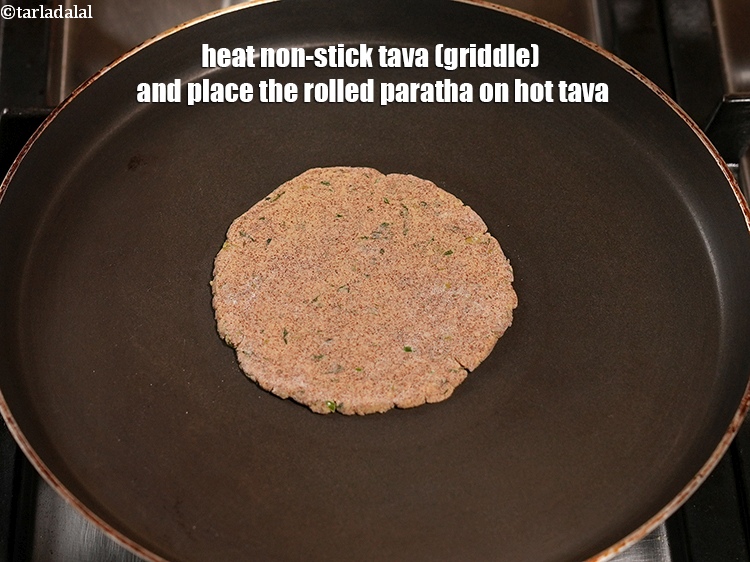 Step 21 – Heat non-stick tava (griddle) and place the rolled paratha on hot tava.