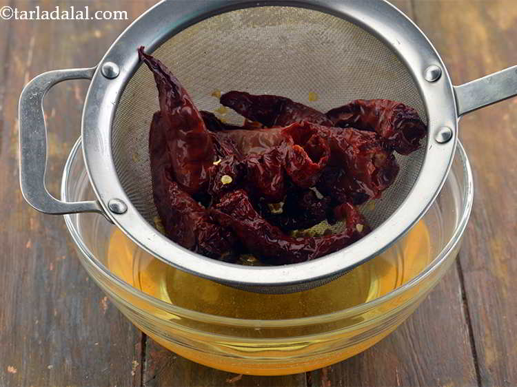 Step 4 – After 15 minutes, drain out all the water from the chillies and discard it.