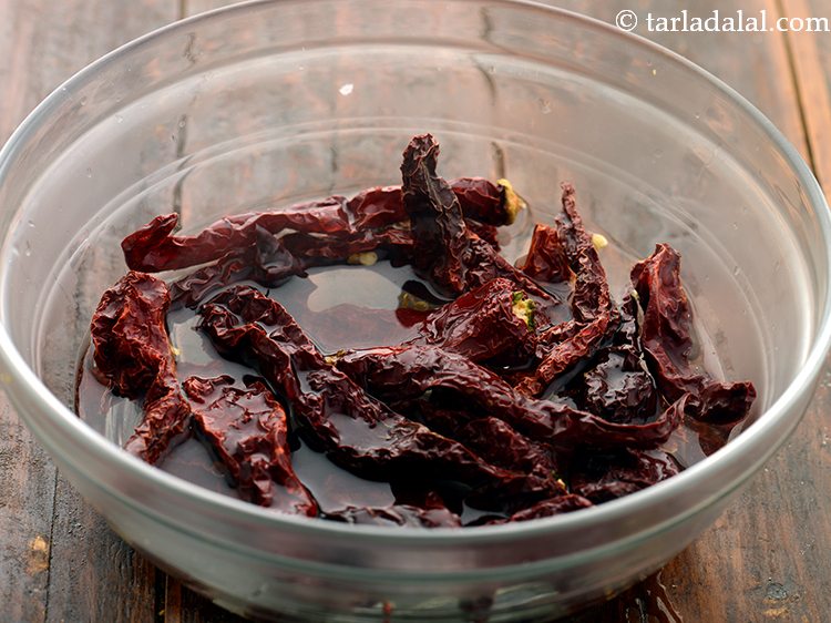 Step 3 – Transfer the water to a deep bowl and add dry red chillies. We have made …