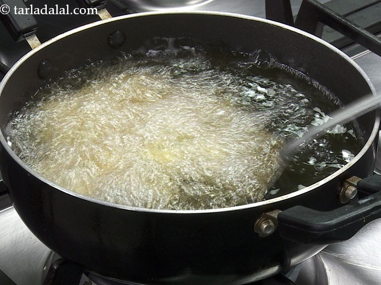 Step 35 – Heat the oil in a deep non-stick pan and add a few balls at a …
