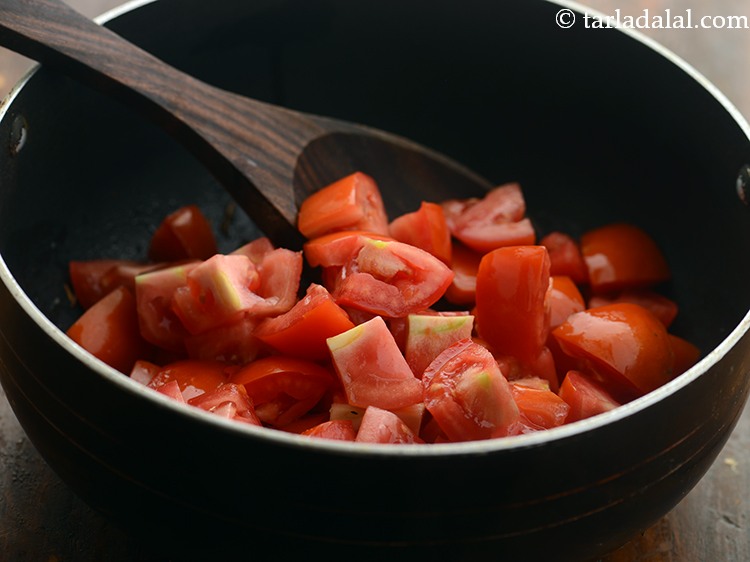Step 6 – When the seeds crackle, add the tomatoes.