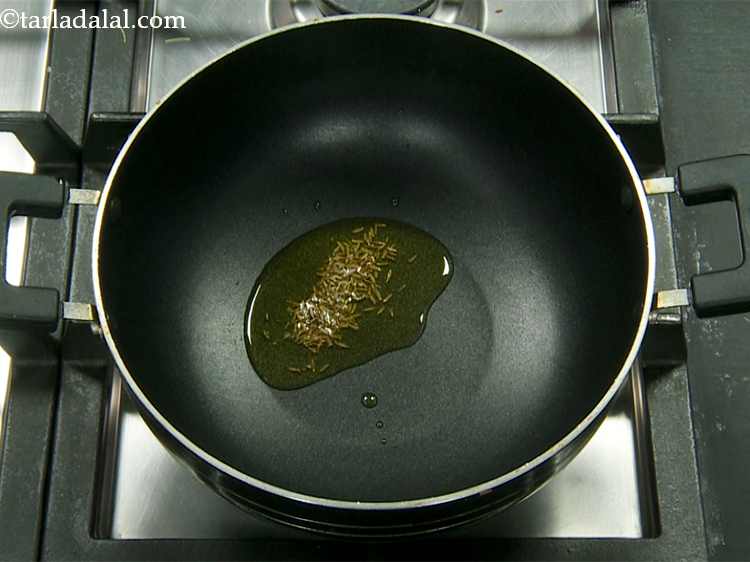 Step 5 – Heat the ghee in the same non-stick kadhai, add the cumin seeds.