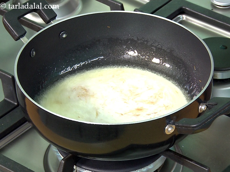 Step 14 – Add 1/4 cup of <a href="https://www.tarladalal.com/glossary-milk-doodh-full-fat-milk-buffalo-milk-full-cream-milk-514i">milk</a>.