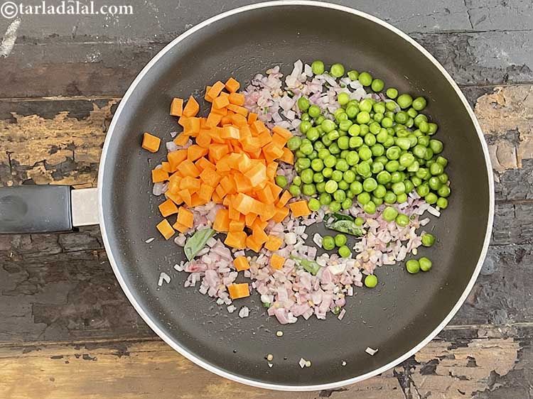 Step 14 – Add&nbsp;<meta charset="UTF-8" />1/2 cup&nbsp;<a href="glossary-green-peas-matar-hare-matar-vatana-180i">green peas</a>.