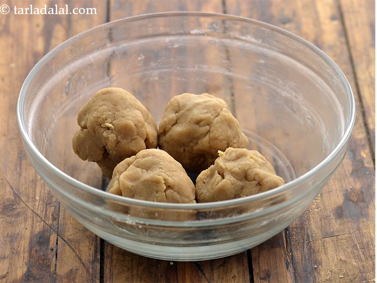 Step 13 – To make <strong>sweet shakarpara recipe</strong>, divide the dough into 4 equal portions.