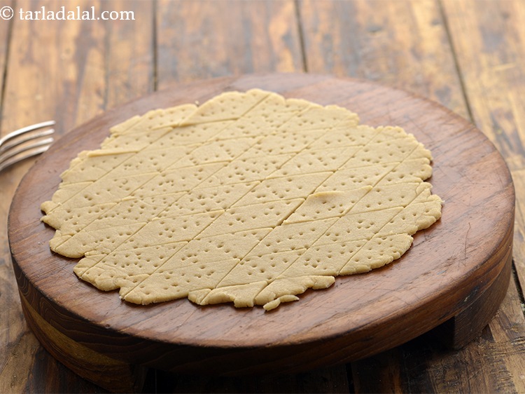 Step 17 – Prick each diamond with a fork. This prevents the shakarpala from puffing up.