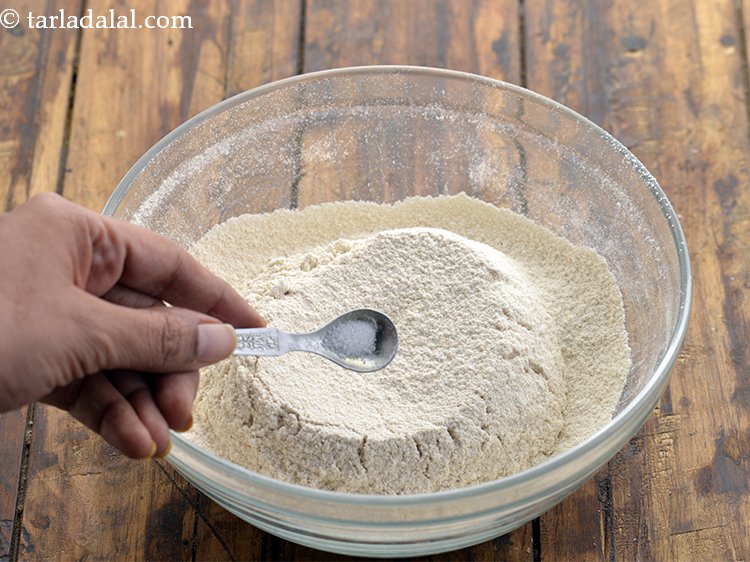 Step 10 – Add salt. They enhance the sweetness in the dough giving <strong>shakarpara</strong> a balanced flavour.