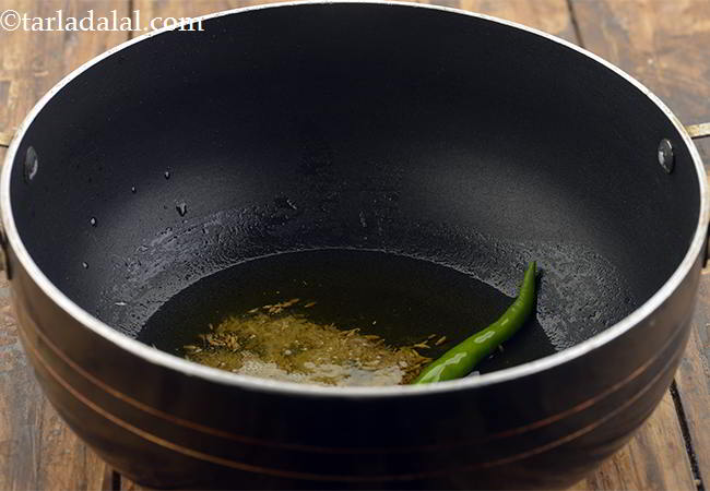 Step 9 – Allow them to crackle and add the green chilli. If you want the dal to …