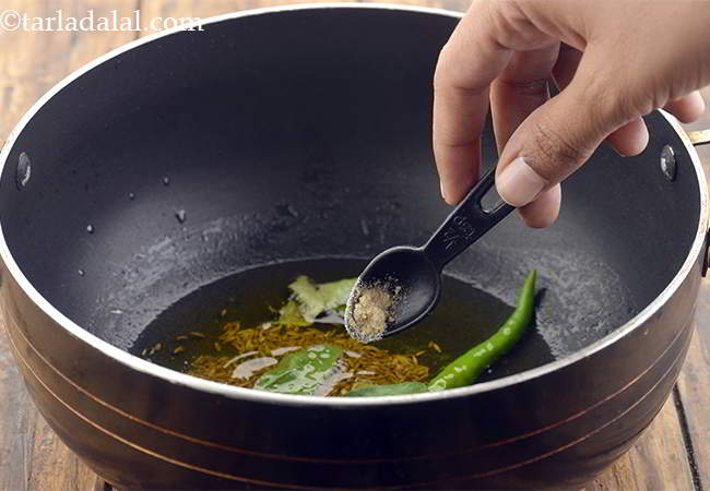 Step 11 – Also add a pinch of hing, mix well and saut&eacute; for 30 seconds.