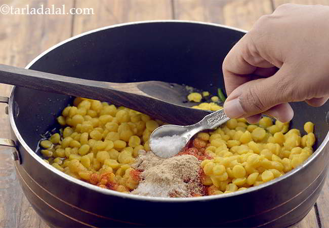 Step 15 – Also add a little salt. Remember that we have already salted the dal while pressure …