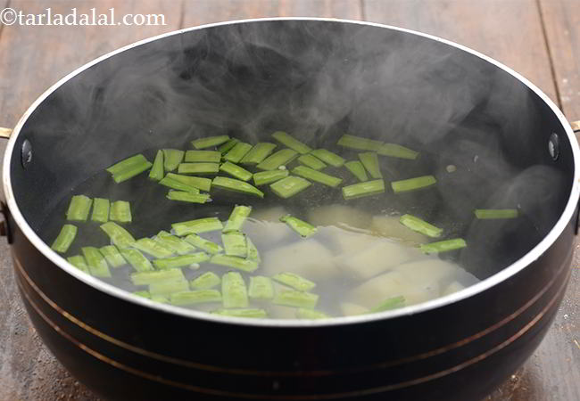 स्टेप 3 – गवरफली, आलू डालें और उन्हें नरम होने तक पकाएं। उसे …