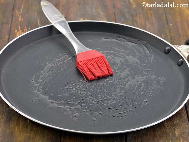 Step 19 – Heat a non-stick tava (griddle) and grease it with &frac12; tsp of ghee.