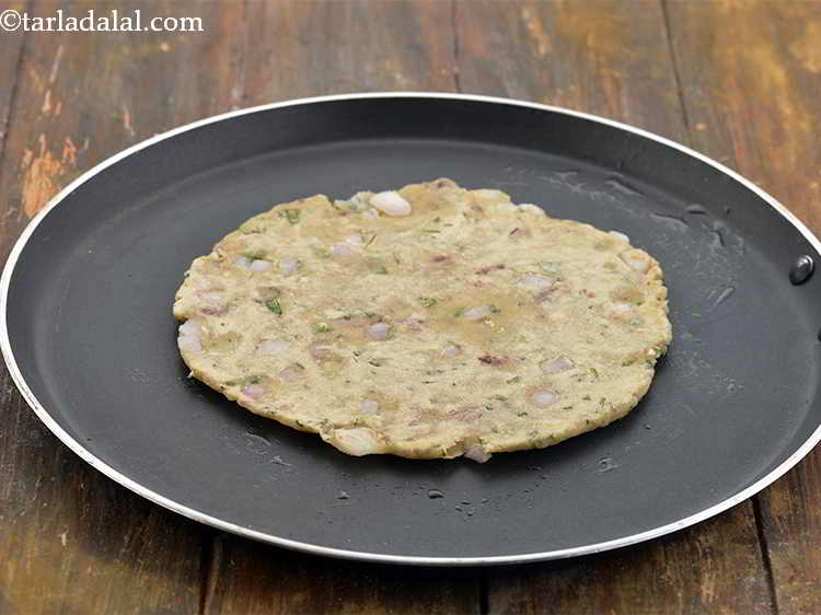 Step 20 – Place the rolled out Sindhi Koki on it and cook on a slow flame.