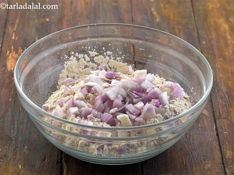 Step 6 – Add the <a href="https://www.tarladalal.com/glossary-onions-548i#ing_722" target="_blank">chopped onions</a> to the dough. We add them for the desired …