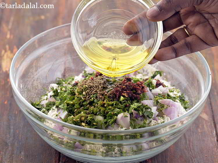 Step 11 – Also, add the melted <a href="https://www.tarladalal.com/glossary-ghee-245i" target="_blank">ghee</a>. This is added to condition the dough.