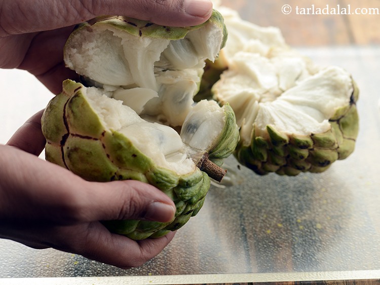 Step 3 – Break each custard apple into 2 with your hands.