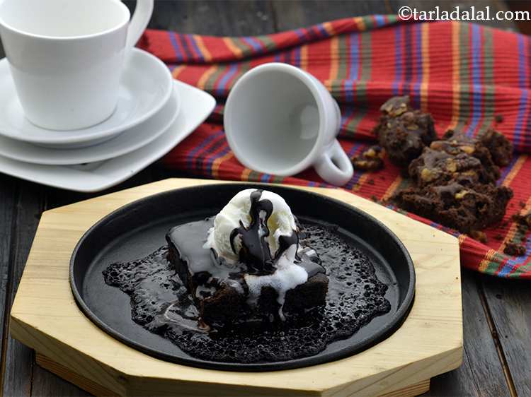 Step 26 – Place the plate on the wooden tray and serve&nbsp;<strong>sizzling brownie | eggless sizzling brownie | …