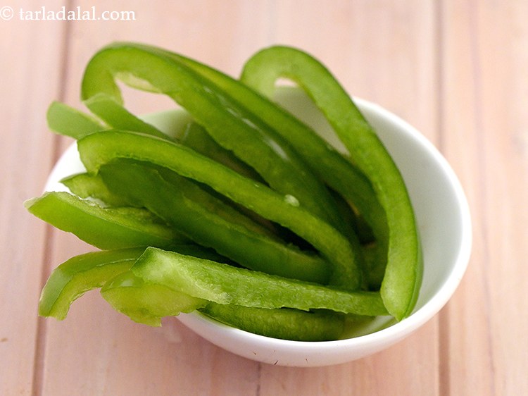 Step 30 – Spread 1/8 cup <a href="https://www.tarladalal.com/glossary-sliced-capsicum-165i">sliced capsicum</a>&nbsp;evenly over it.