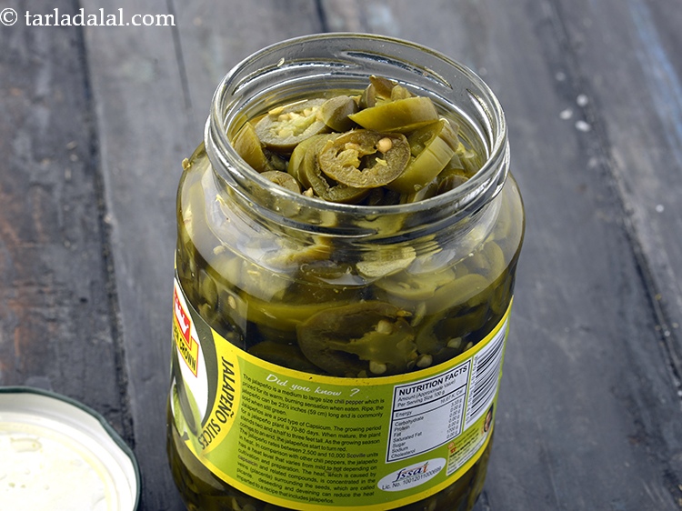 Step 31 – Spread 5 <a href="https://www.tarladalal.com/glossary-sliced-jalapenos-1783i">sliced jalapenos</a> evenly over it.