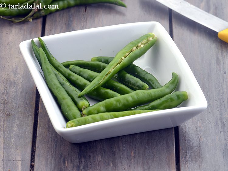 Step 16 – When the seeds crackle, add 2&nbsp;<a href="https://www.tarladalal.com/glossary-slit-green-chillies-1856i">slit green chillies</a>. Though we have used slit green …