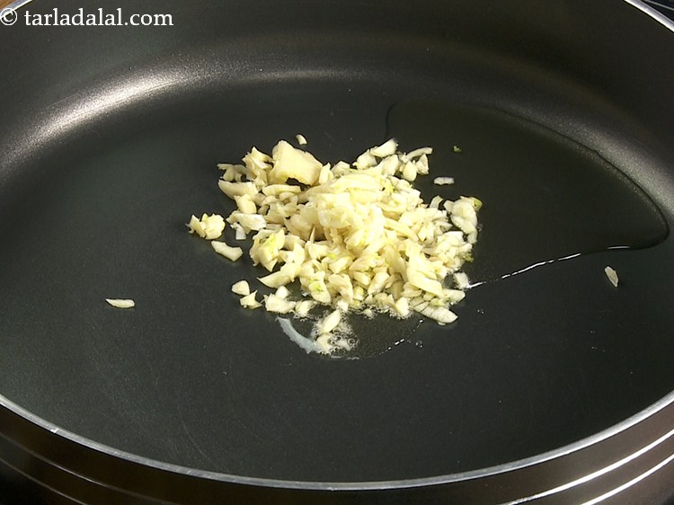 Step 11 – Once the oil is hot, add the garlic.