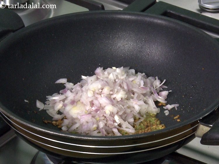 Step 14 – Add finely chopped onions. <a href="https://www.tarladalal.com/article-onion-benefits--290" target="_blank"><strong>Read Benefits of onions.</strong></a>