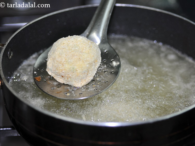 Step 34 – For frying <strong>spaghetti balls</strong>, heat the oil in a deep non-stick kadhai, and carefully drop …